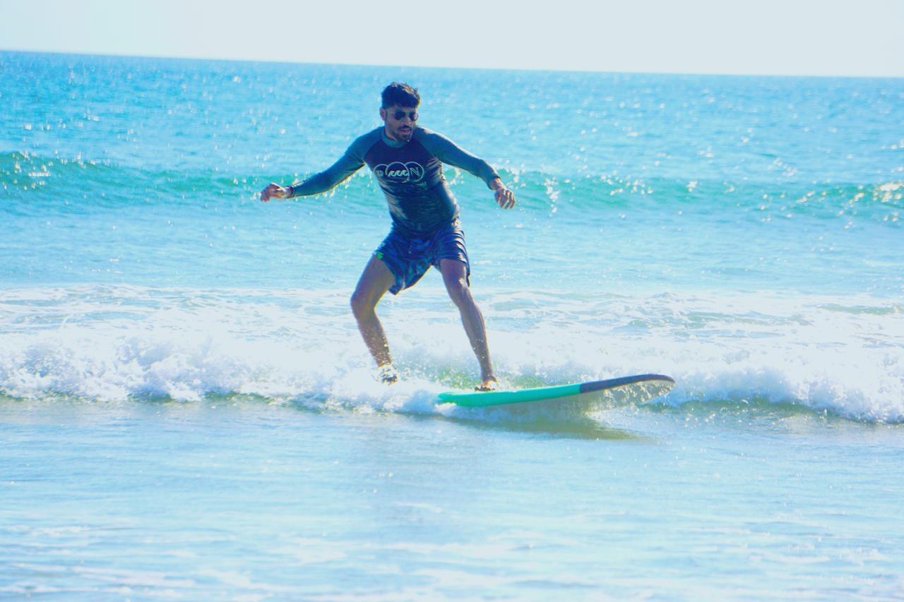 Soumik, co-founder of Mighosh, surfing a small wave
